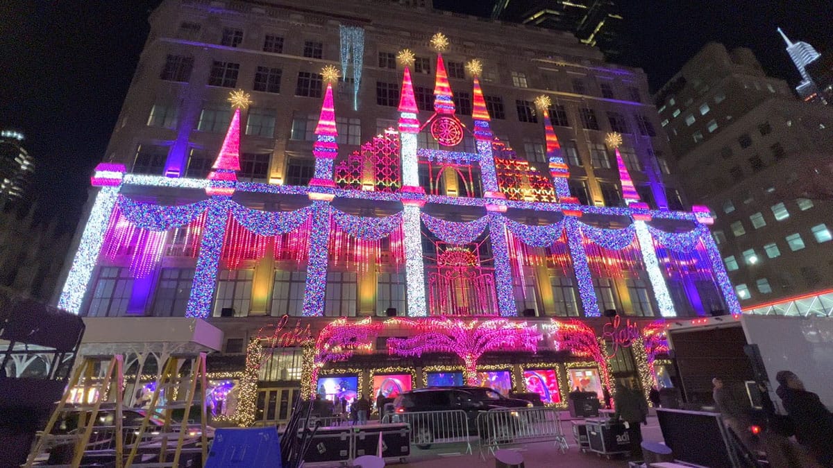 large building illuminated with Christmas lights and projections.