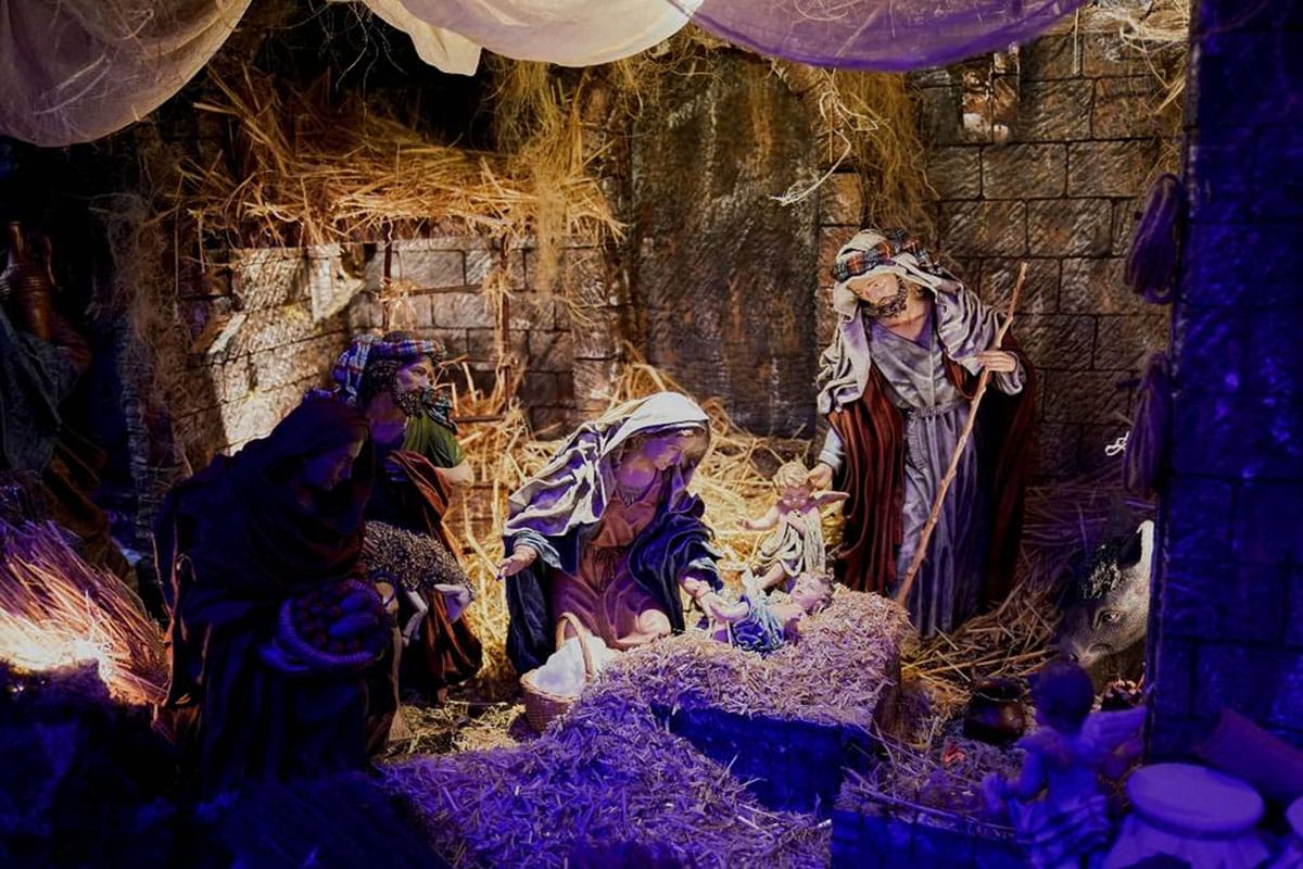 large Nativity scene illuminated at night.