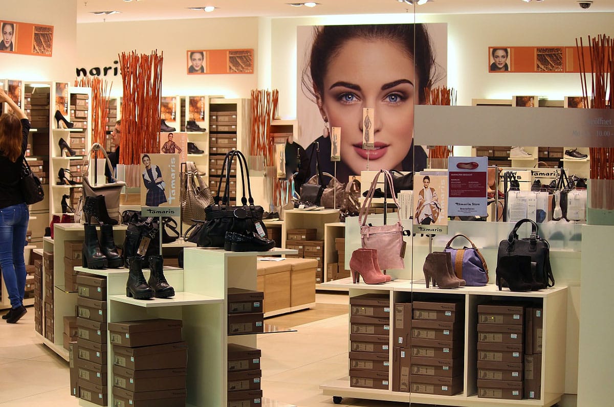 displays of women's shoes and purses in a store in Barcelona.
