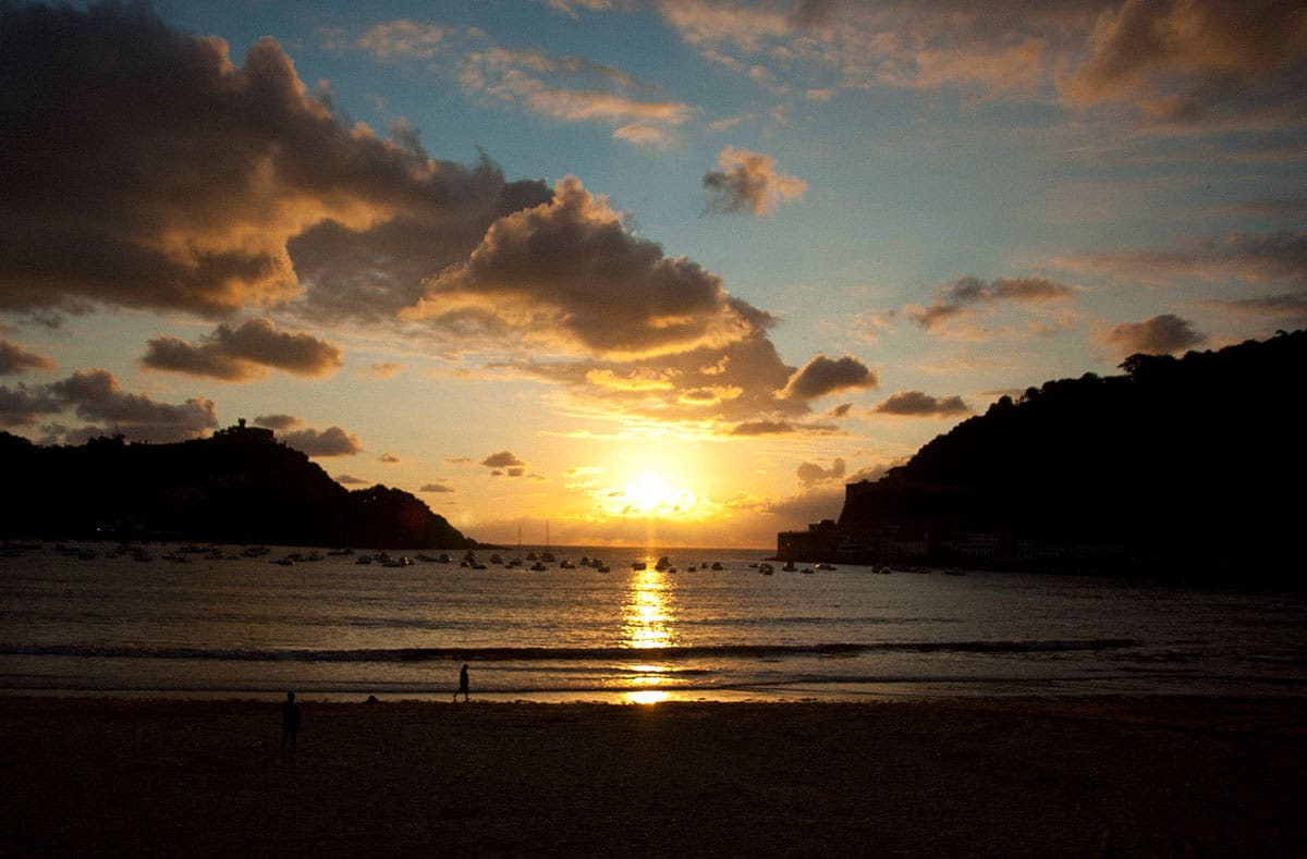 sunset from La Concha Beach with the sun glinting on the waves.