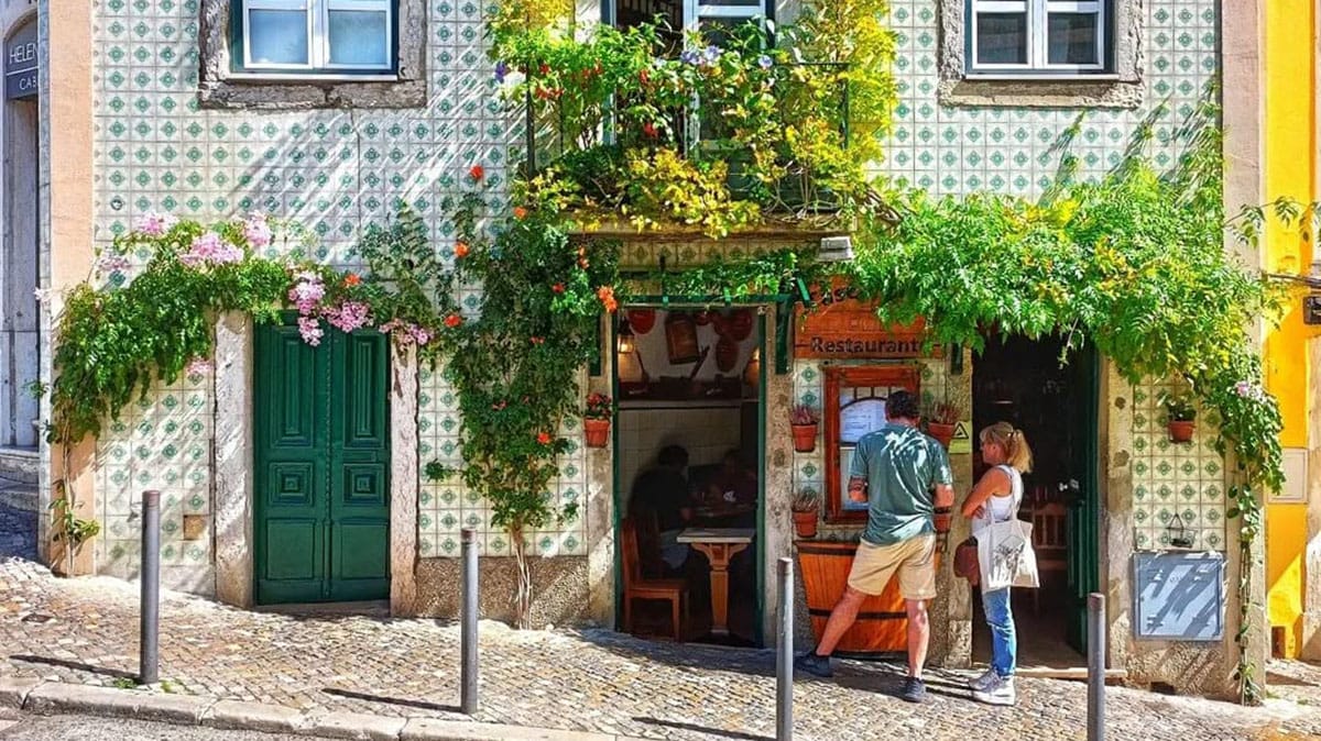 tiled building with a flowering vine growing on it.