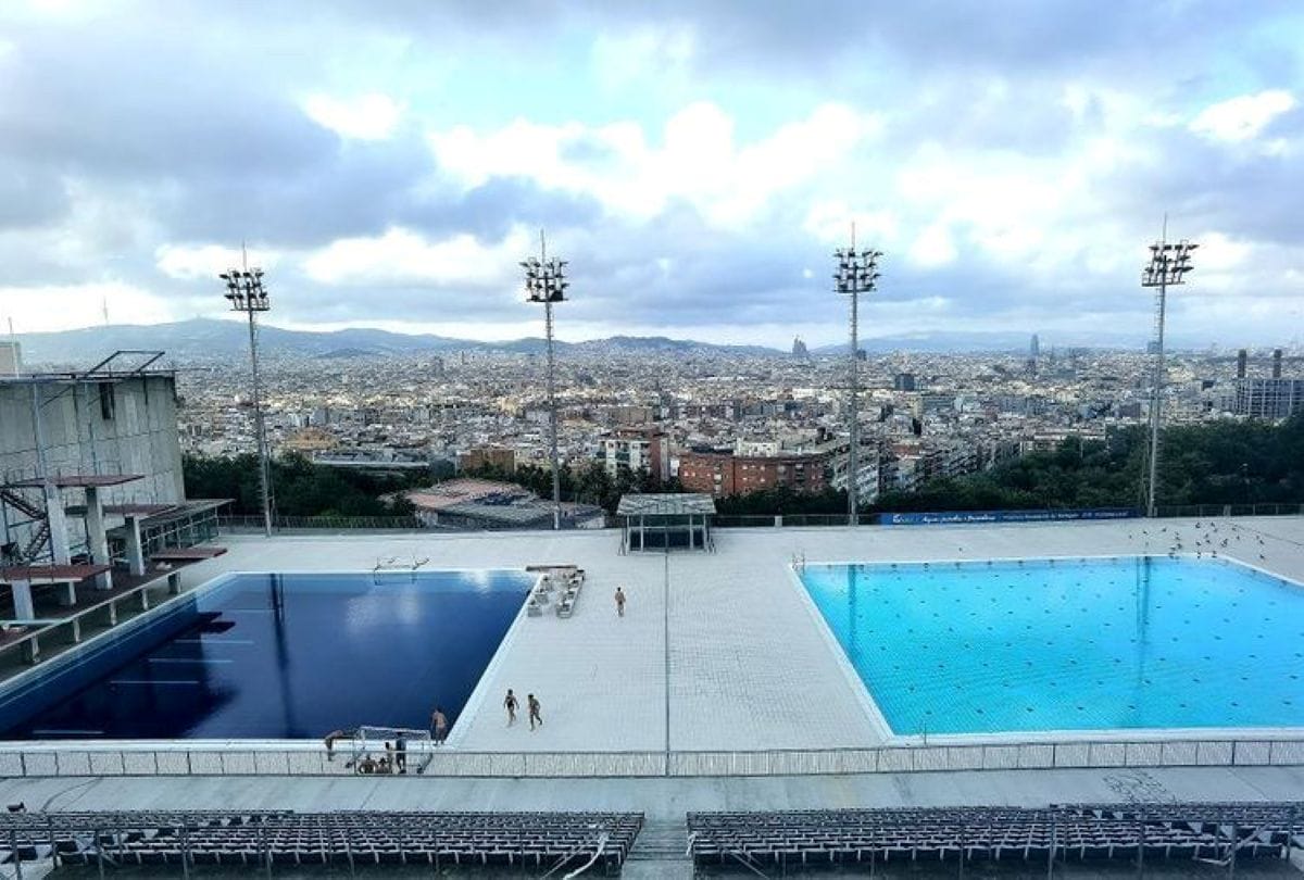 People hanging out at an An Olympic pool in Barcelona.