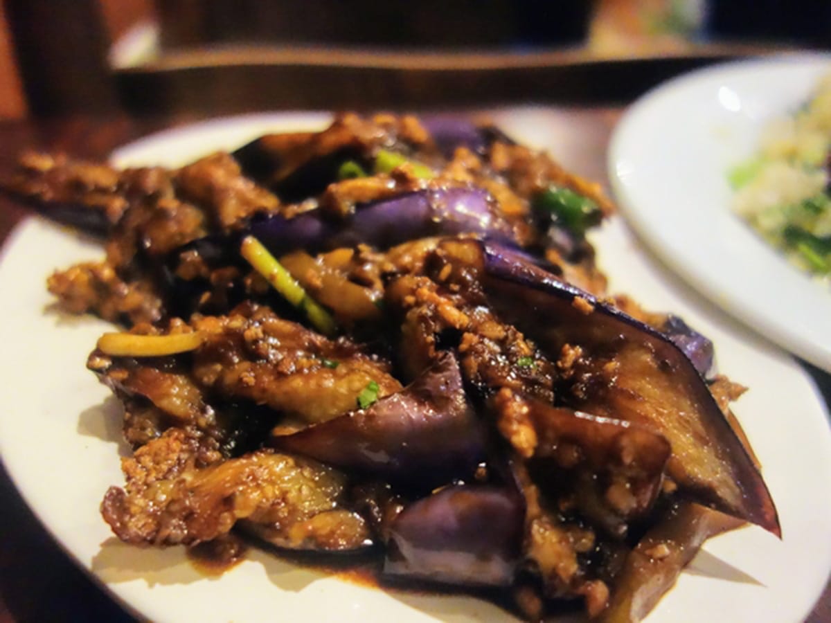 white platter of saut&eacute;ed eggplant.