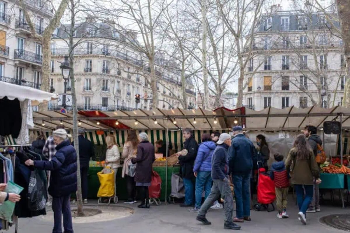 crowded market stalls in a Paris street.