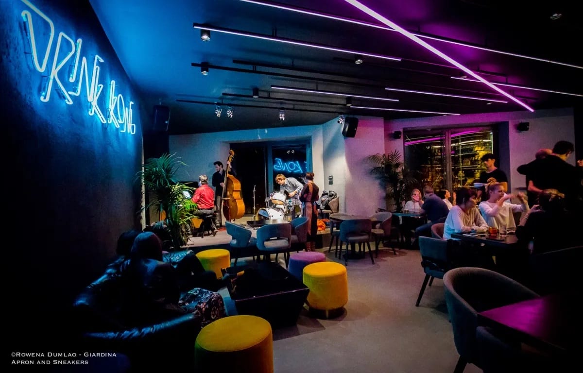 live jazz band playing in a neon-lit bar.