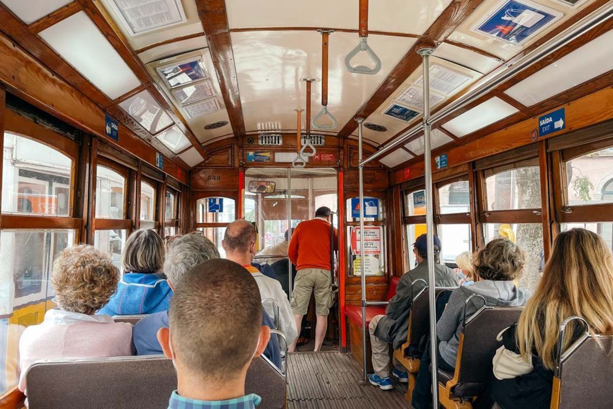 people sitting on benches in a tram.