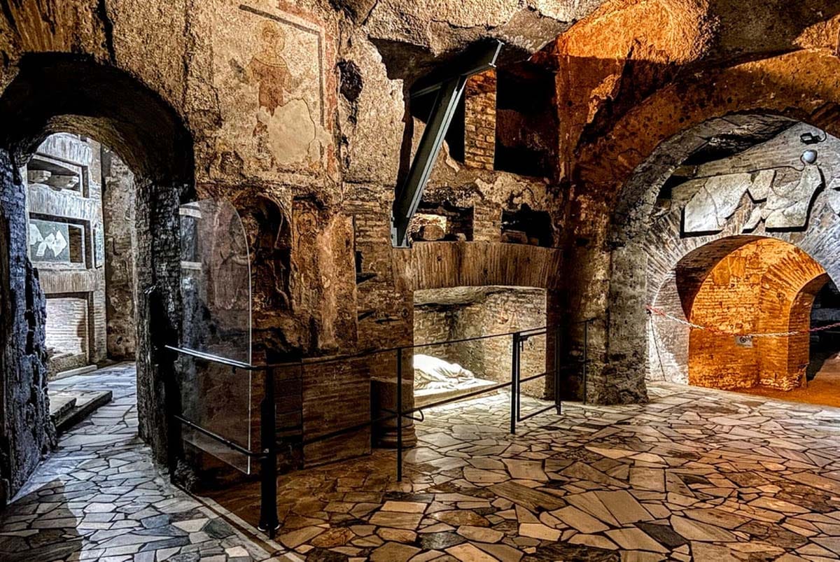 arched passageways and doorways and mosaics in stone catacombs.