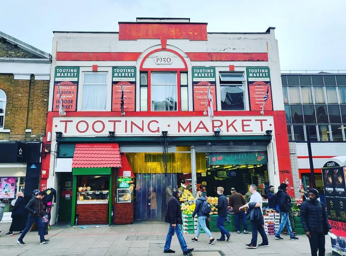large, two-story building with a large sign for Tooting Market on the building above the entrance.