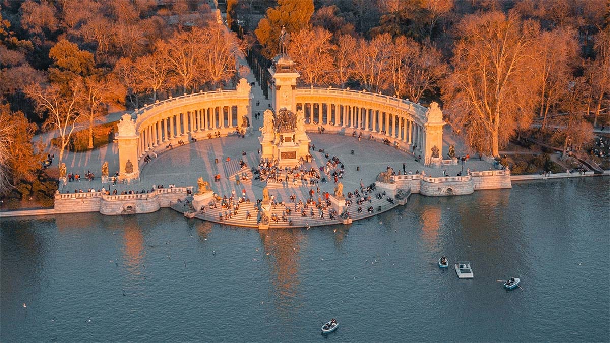 golden evening light falling upon a columned portico with steps down to a river.