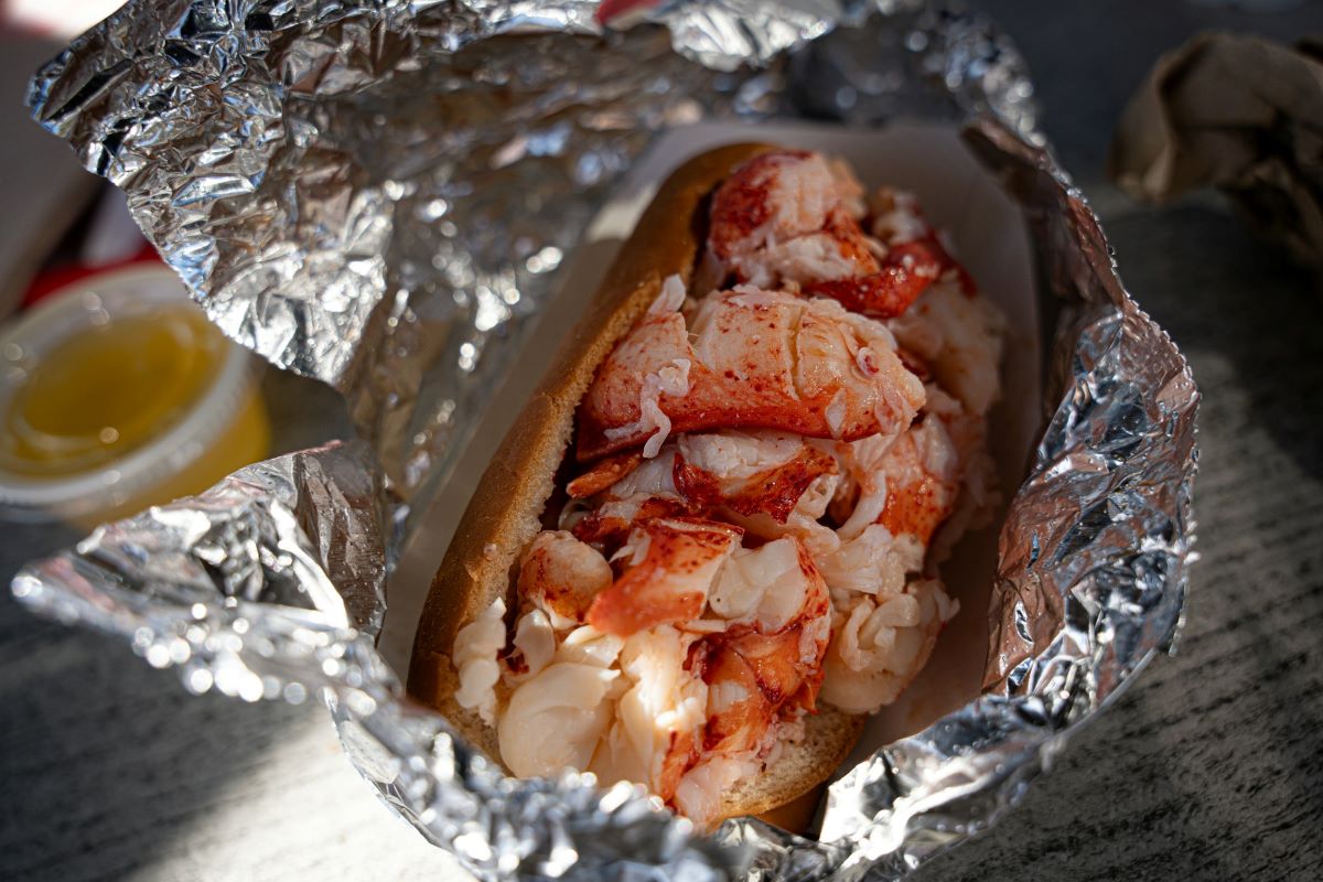 A lobster roll, a Boston famous food, wrapped in foil. 